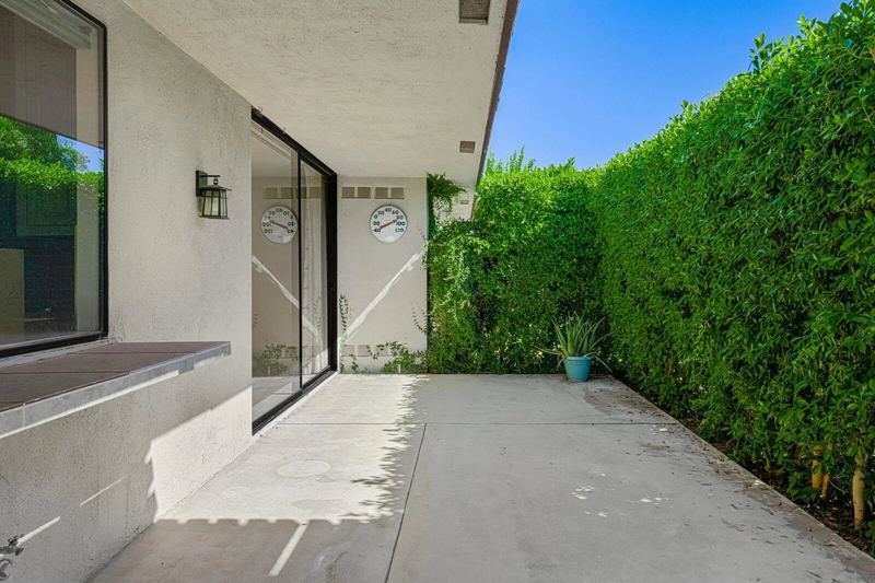 Courtyard entry with hedge wall
