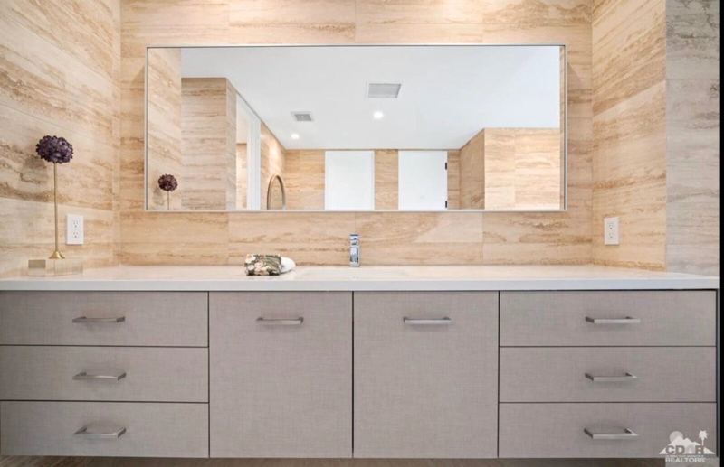 Floating vanity with travertine wall