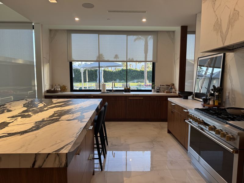 Kitchen with marble island and walnut cabinetry