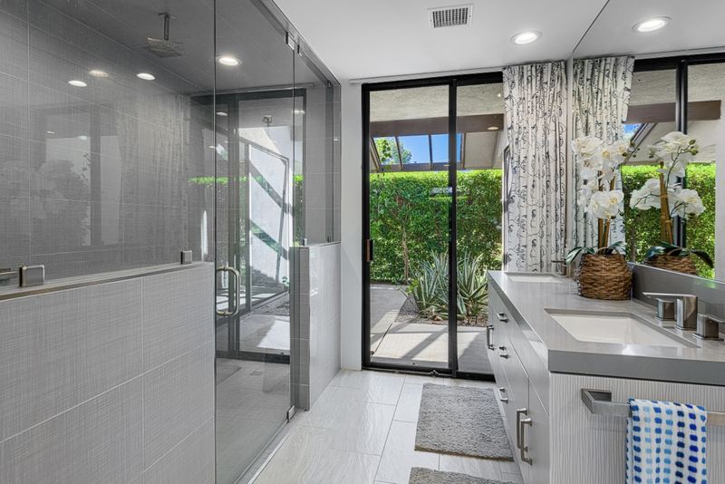 Remodeled bathroom with glass shower and garden view